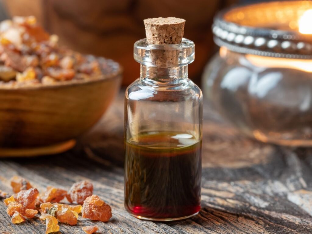 Frankincense essential oil bottle with Frankincense on a table