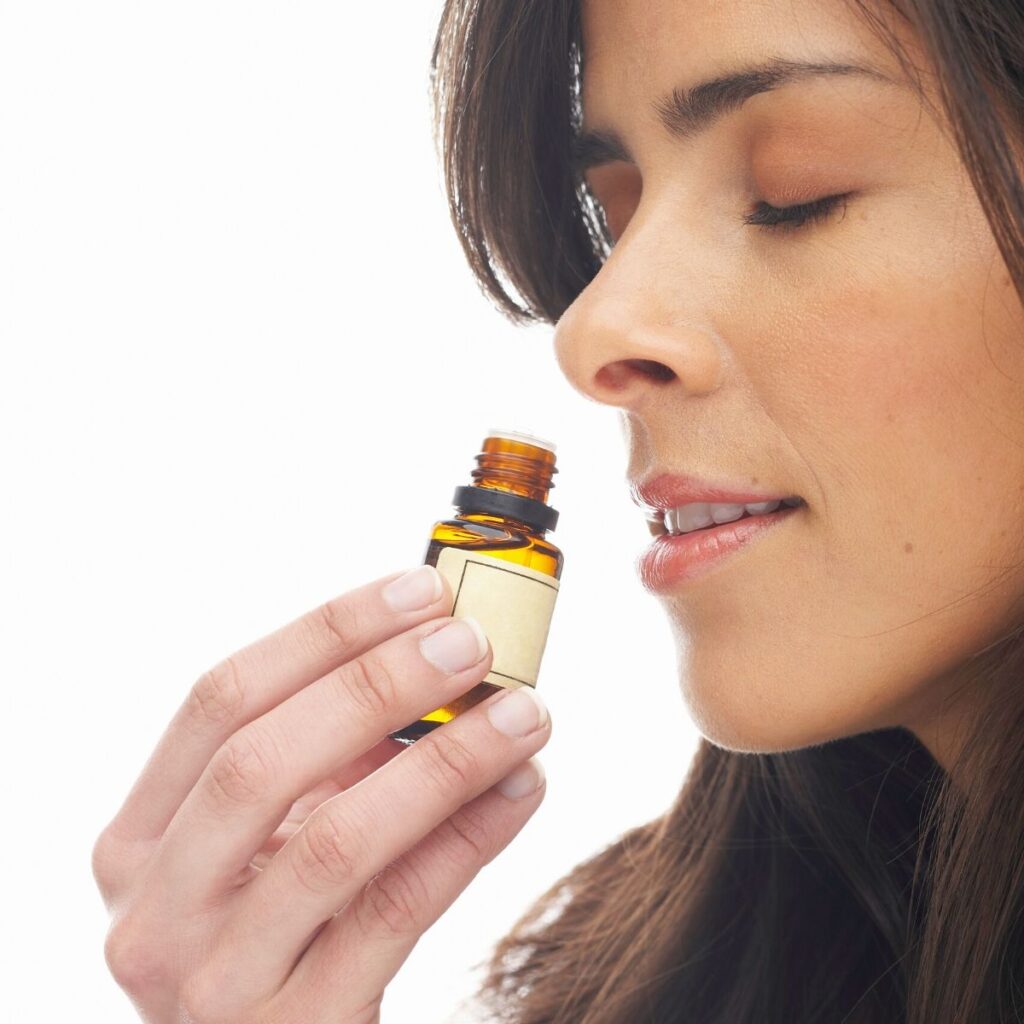 woman inhaling essential oil