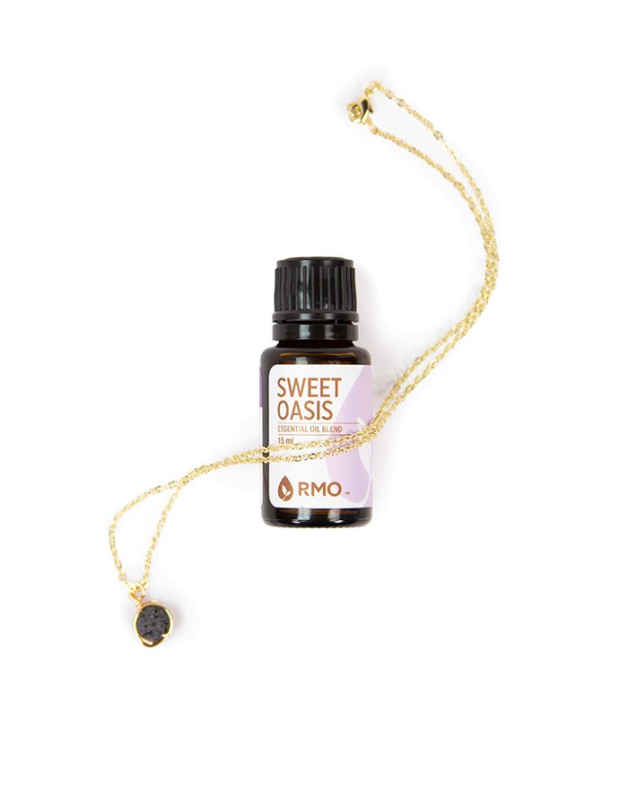lava ball necklace with bottle of essential oil