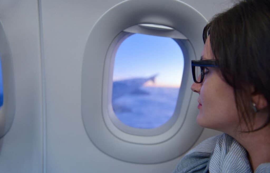 woman sitting in a window seat on airplane