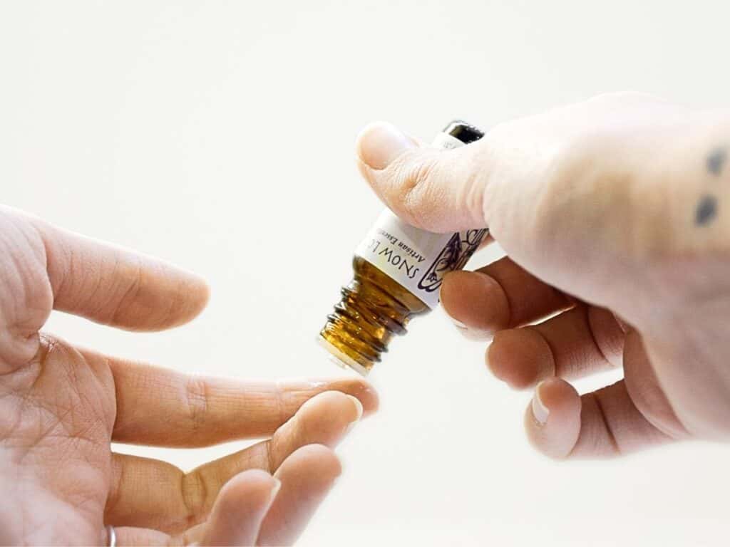 hand applying essential oil