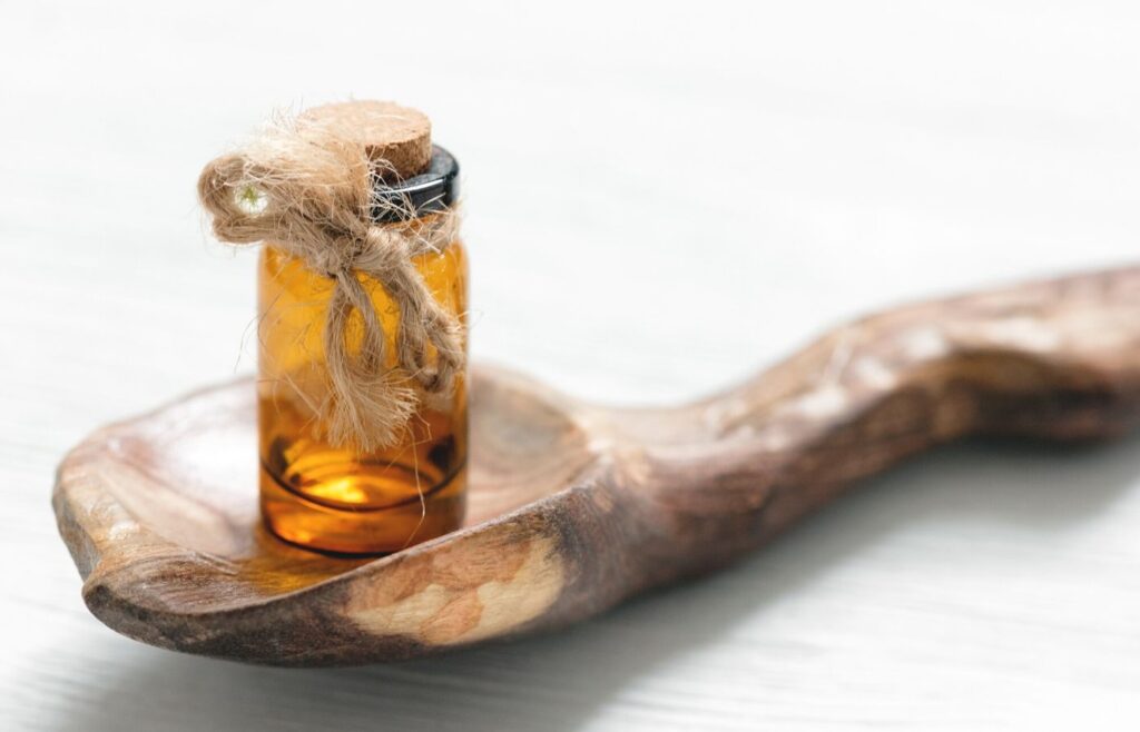 wooden spoon with essential oil bottle on it