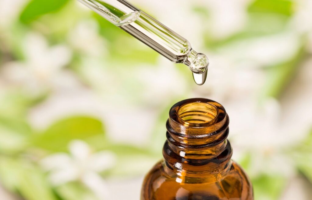 essential oil bottle dropping a drop of oil