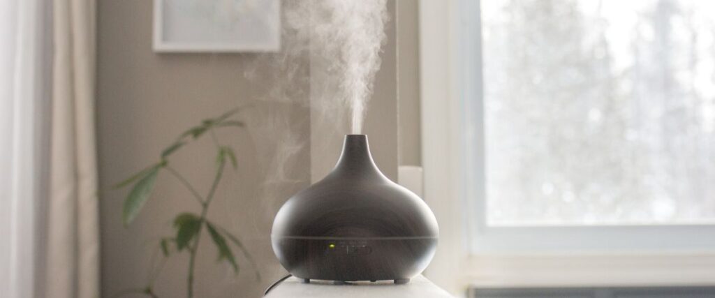 oil diffuser diffusing essential oils on table