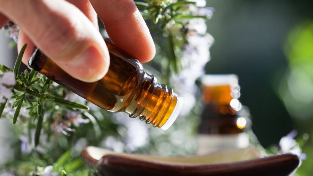 essential oil bottle dropping into bowl