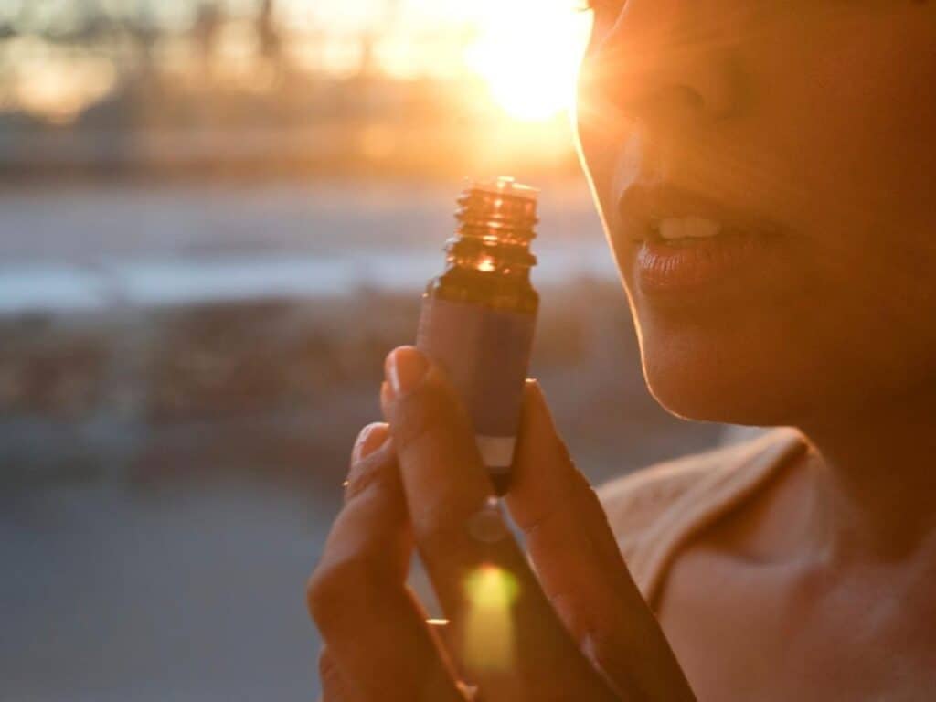 woman inhaling ssential oils for coping with alcohol addiction