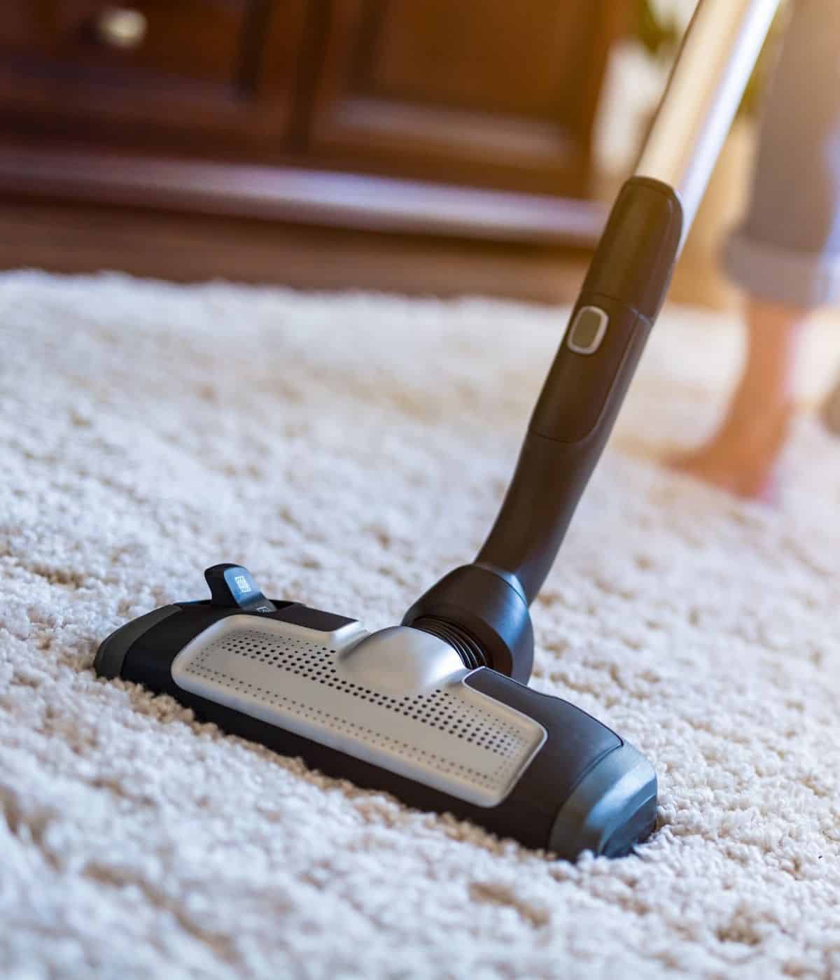 Vacuuming a carpet.