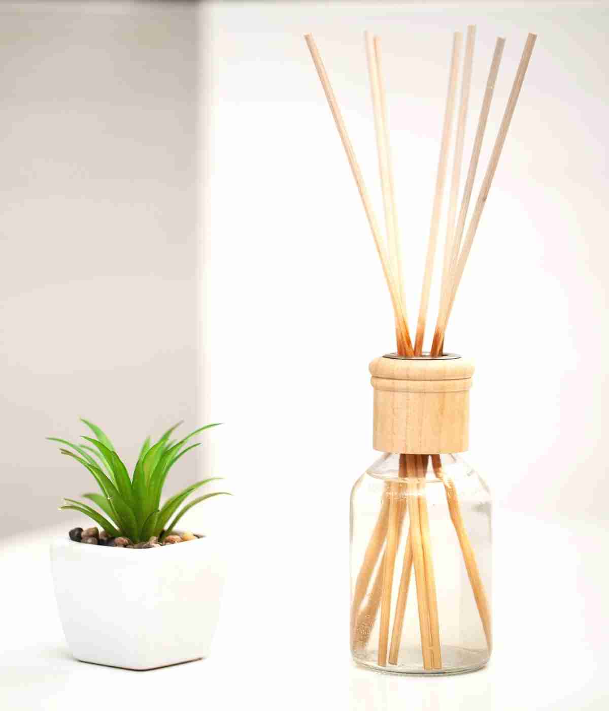 Wooden reed diffuser on table.