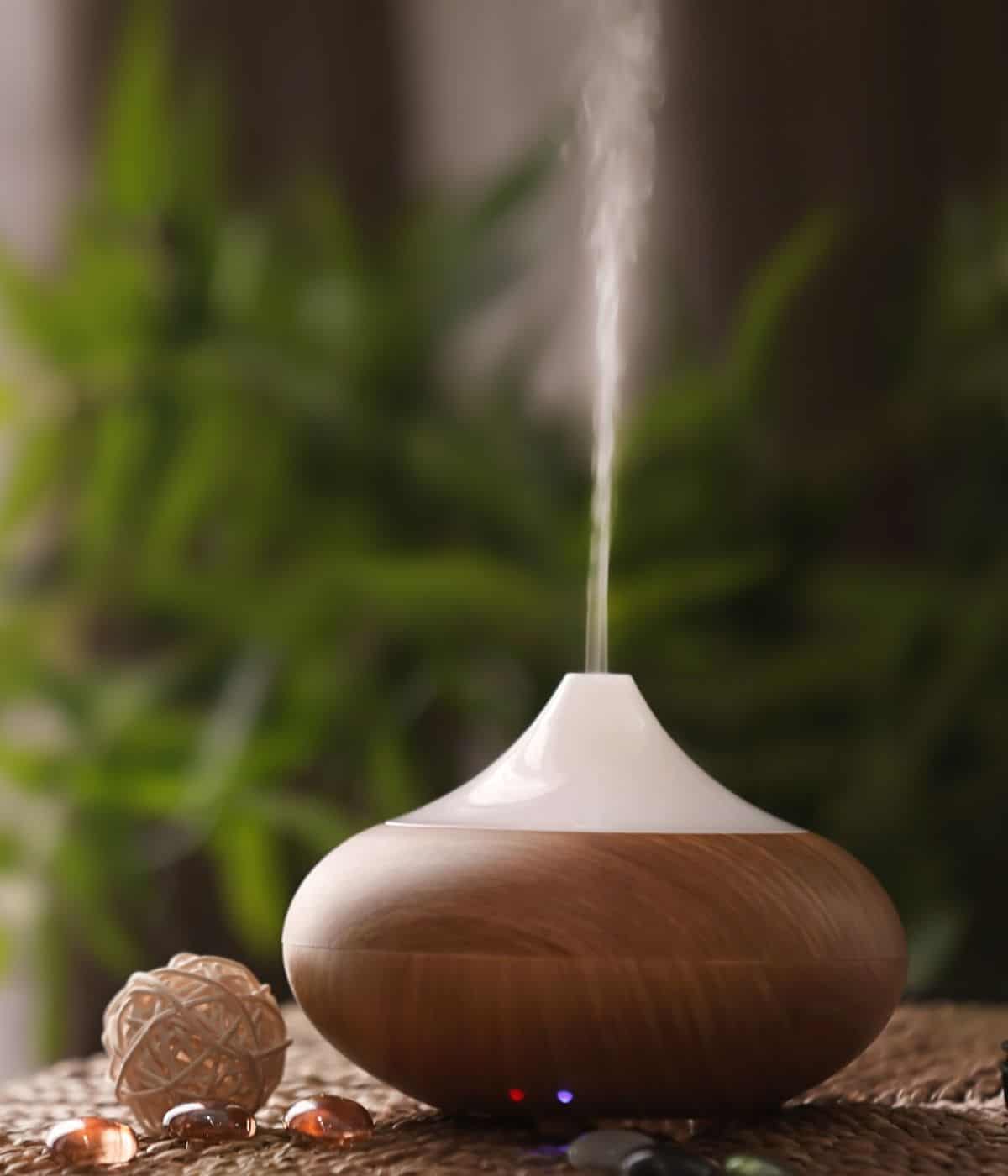 Diffuser on table spewing mist.