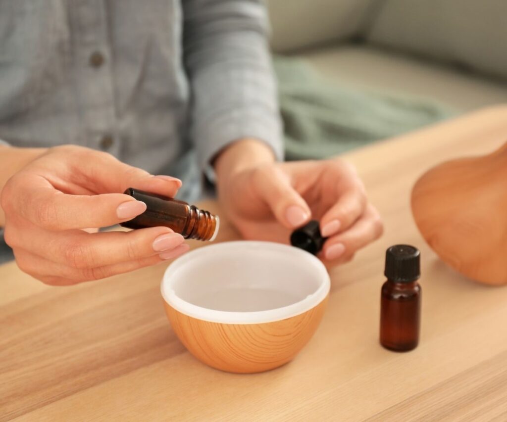 Essential oil diffuser adding oils.