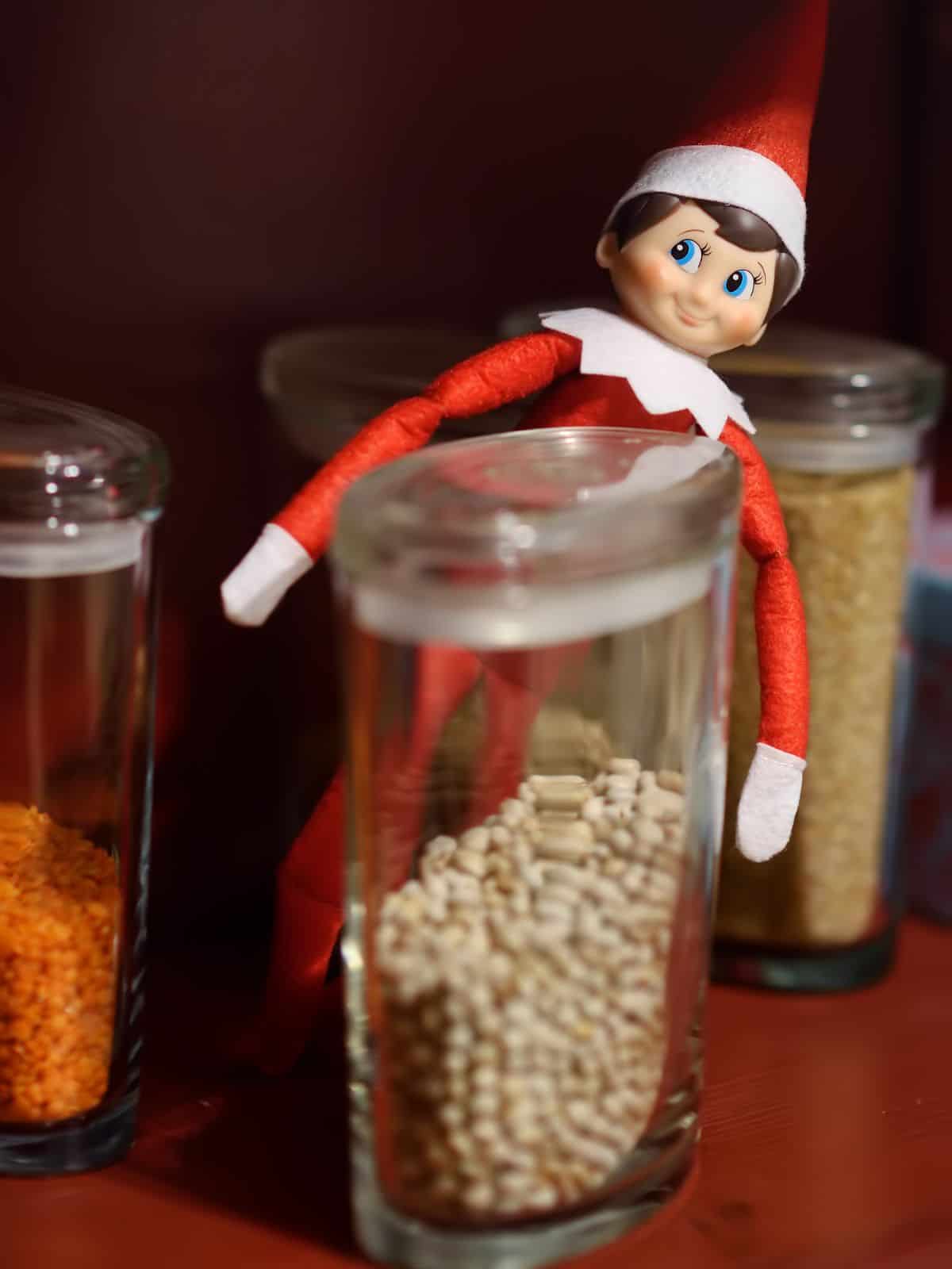 Elf on the shelf with food in pantry.